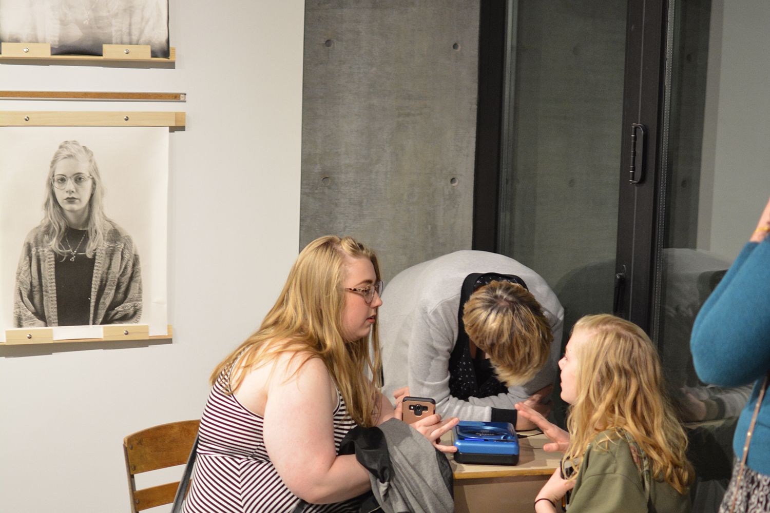 Faimly members of the person in the portrait listening to the oral history recording.