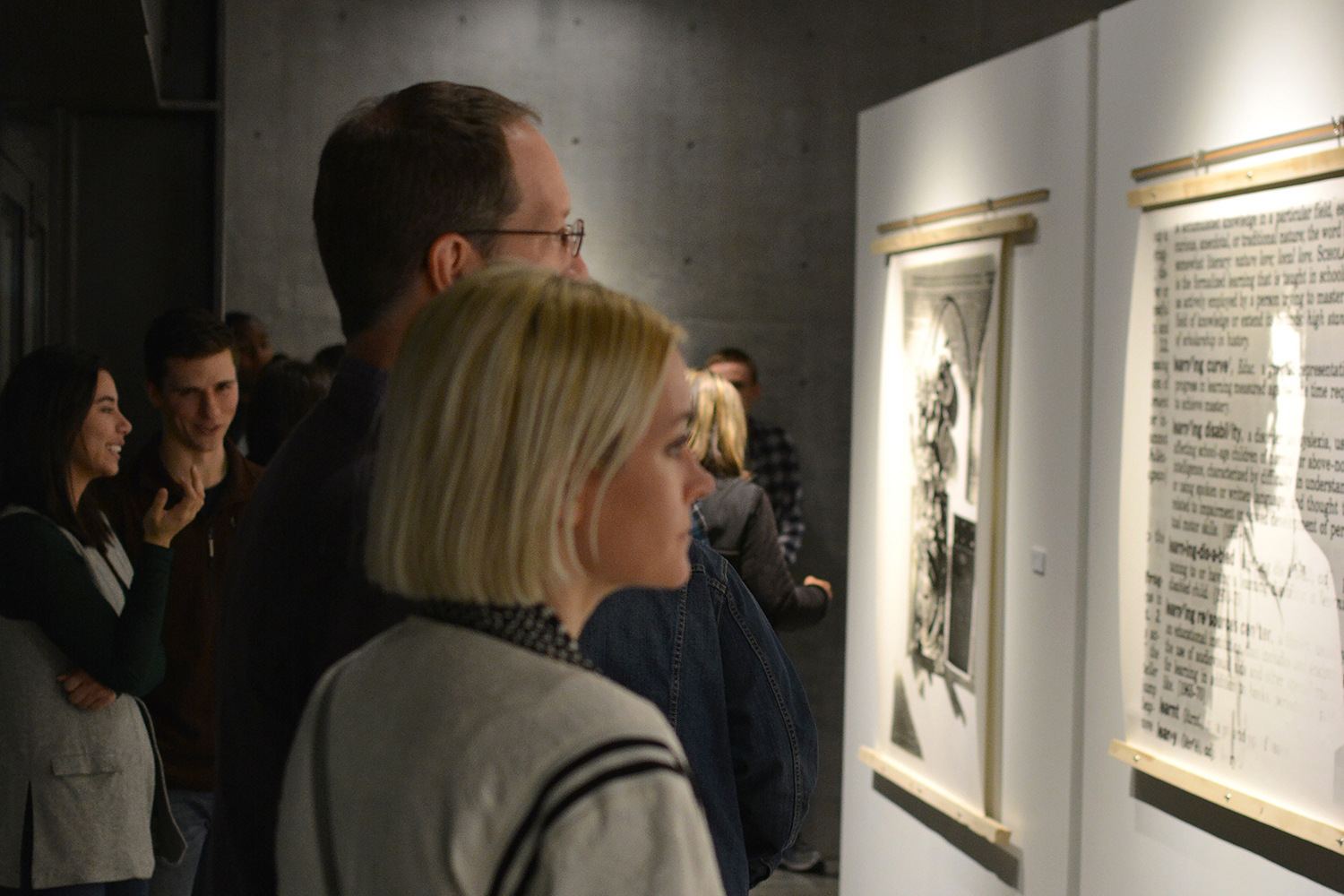 Poeple looking at the large scale gelatin silver prints.